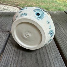 Load image into Gallery viewer, Matcha Tea Pottery Drink Tumbler laying on its side showing bullseye design along bottom one-third of the outside.