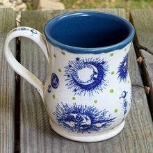 Load image into Gallery viewer, You can see the cosmos in this handcrafted pottery mug in blues, green and beige.