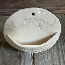 Load image into Gallery viewer, Decorative ceramic wall piece with dolphin design on a wooden surface
