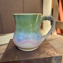 Load image into Gallery viewer, Multicolored ceramic mug on a metal surface
