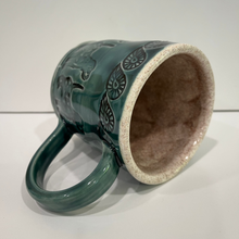 Load image into Gallery viewer, Pottery mug stamped with dogs and leaves.