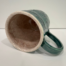 Load image into Gallery viewer, Beige speckled inside of green dog pottery mug.