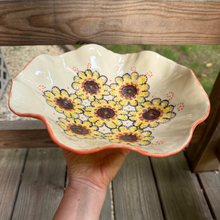 Load image into Gallery viewer, Ceramic bowl with floral design held by a hand on a wooden surface