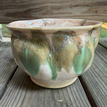 Load image into Gallery viewer, Lovely handmade pottery bowl thrown and altered in muted shades of green, brown and beige sitting on a wooden porch with trees in the background.
