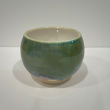 Load image into Gallery viewer, Mini green pottery bowl with white interior on a white background.