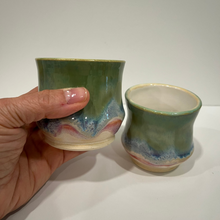 Load image into Gallery viewer, Hand holding a ceramic cup with another similar cup on a white surface