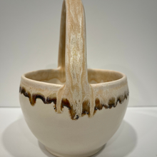 Load image into Gallery viewer, White pottery bowl with beige handle and brown drips around rim.