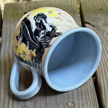 Load image into Gallery viewer, Horse pottery mug laying on its side and showing the light blue interior.
