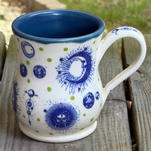 Load image into Gallery viewer, Ceramic mug with blue and white design on a wooden surface
