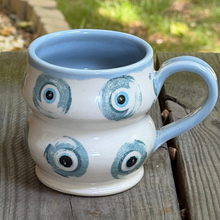 Load image into Gallery viewer, Ceramic mug with blue and white design on a wooden surface

