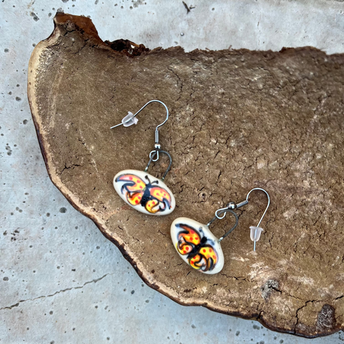 Clay earrings with hand painted butterflies with metal ear wires.