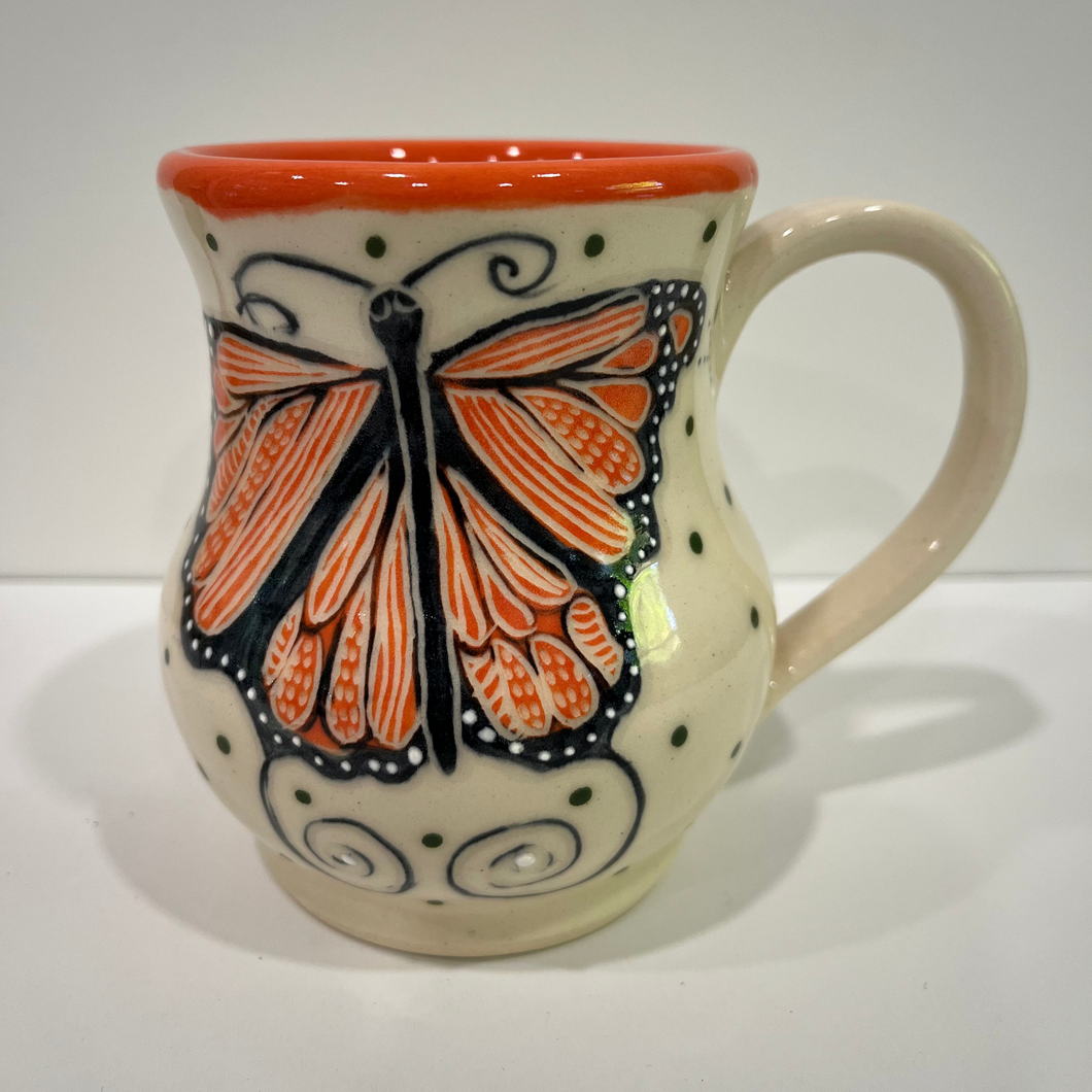 Ceramic mug with a butterfly design on a white background