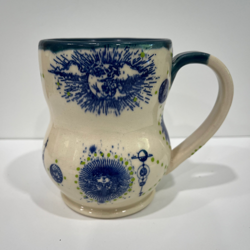 Ceramic mug with blue floral patterns on a white background