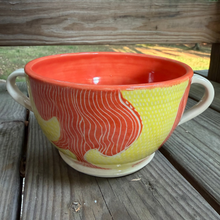 Load image into Gallery viewer, Ceramic bowl with red and yellow design on a wooden surface outdoors
