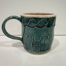 Load image into Gallery viewer, Green ceramic mug with dog and leaf impressions.
