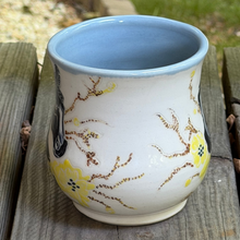 Load image into Gallery viewer, Side view of the black stallion horse pottery mug with light blue interior.
