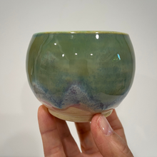Load image into Gallery viewer, Hand holding a small green pottery bowl.
