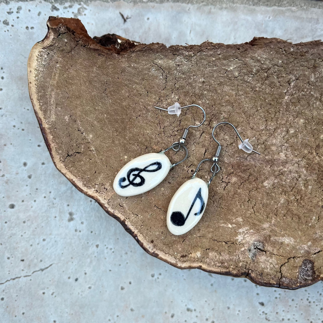 Clay earrings with hand painted musical notes and metal ear wires.