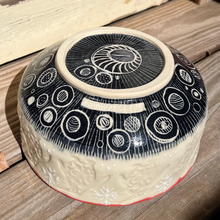 Load image into Gallery viewer, Round black and white patterned pottery bowl on a wooden surface
