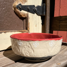 Load image into Gallery viewer, Ceramic bowl with red interior and beige exterior on a wooden surface

