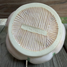 Load image into Gallery viewer, Bottom of multifaceted pottery bowl showing carved lines emanating from the artist's central signature stamp.

