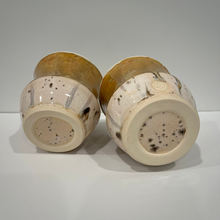 Load image into Gallery viewer, Bottom view of pair of pottery drink tumblers.

