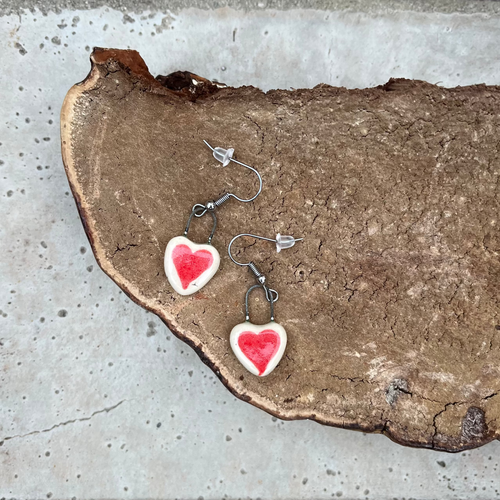 Heart-shaped earrings on a piece of mushroom