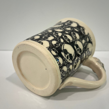 Load image into Gallery viewer, Ceramic mug with skull pattern on a white background
