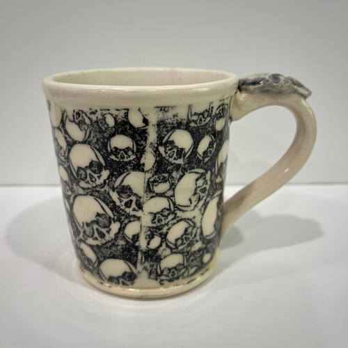 Ceramic mug with skull pattern on a white background