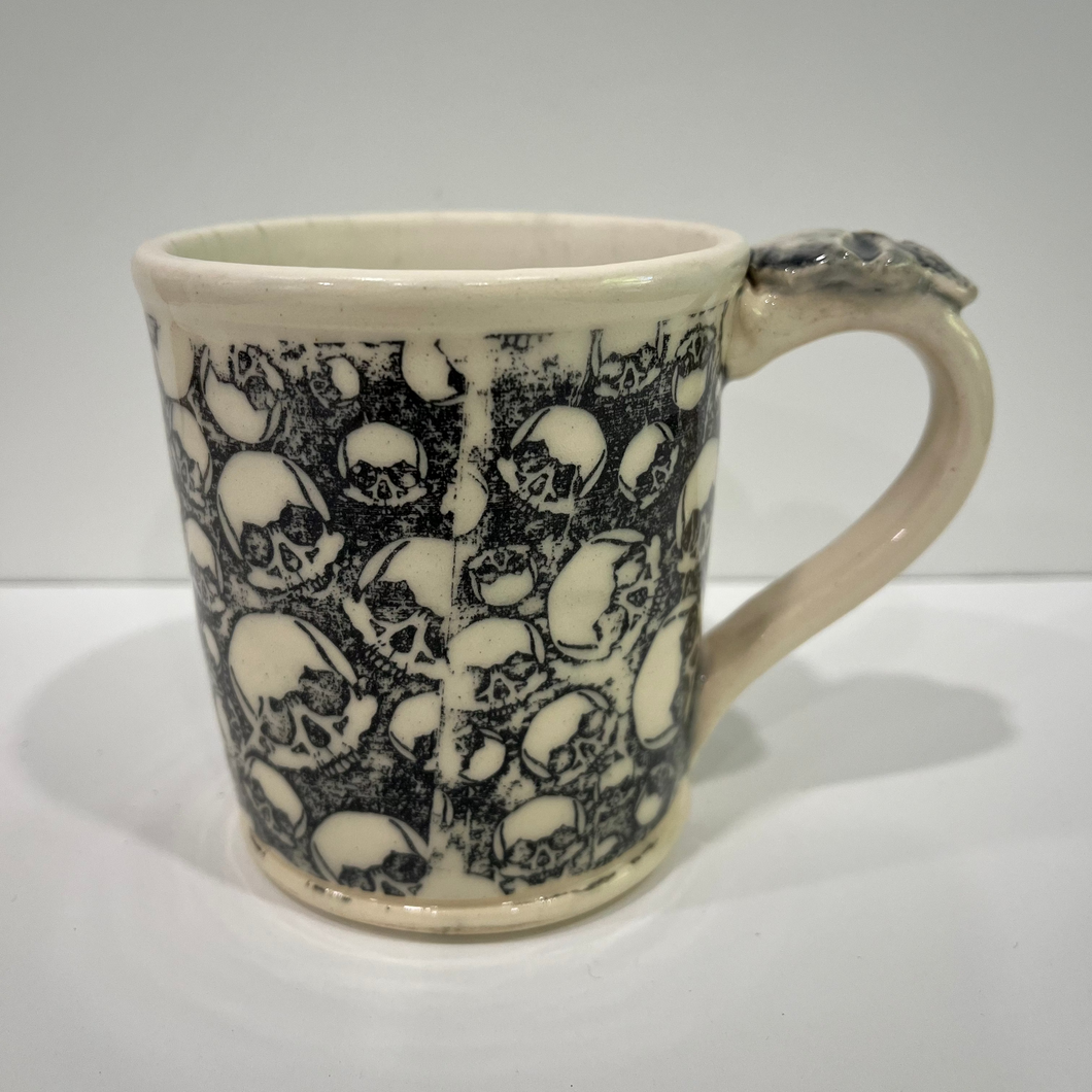Ceramic mug with skull pattern on a white background