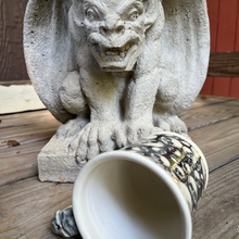 Load image into Gallery viewer, Stone gargoyle statue with a ceramic mug on a wooden surface
