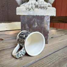 Load image into Gallery viewer, Skull detail on handle of skull pottery mug.
