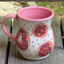 Load image into Gallery viewer, Ceramic mug with pink interior, decorative exterior on a wooden surface
