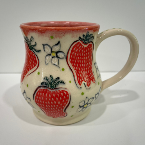 Ceramic mug with strawberry design on a white background