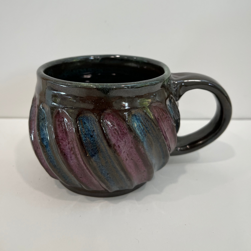 Blue and purple swirls on a brown pottery mug
