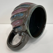 Load image into Gallery viewer, Ceramic mug with ribbed design on a brown background
