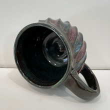 Load image into Gallery viewer, Ceramic mug with decorative handle on a brown background
