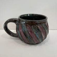 Load image into Gallery viewer, Dark brown pottery mug with blue and purple swoops.
