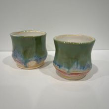 Load image into Gallery viewer, Two petite pottery drink tumblers glazed in green, blue, pink and white.
