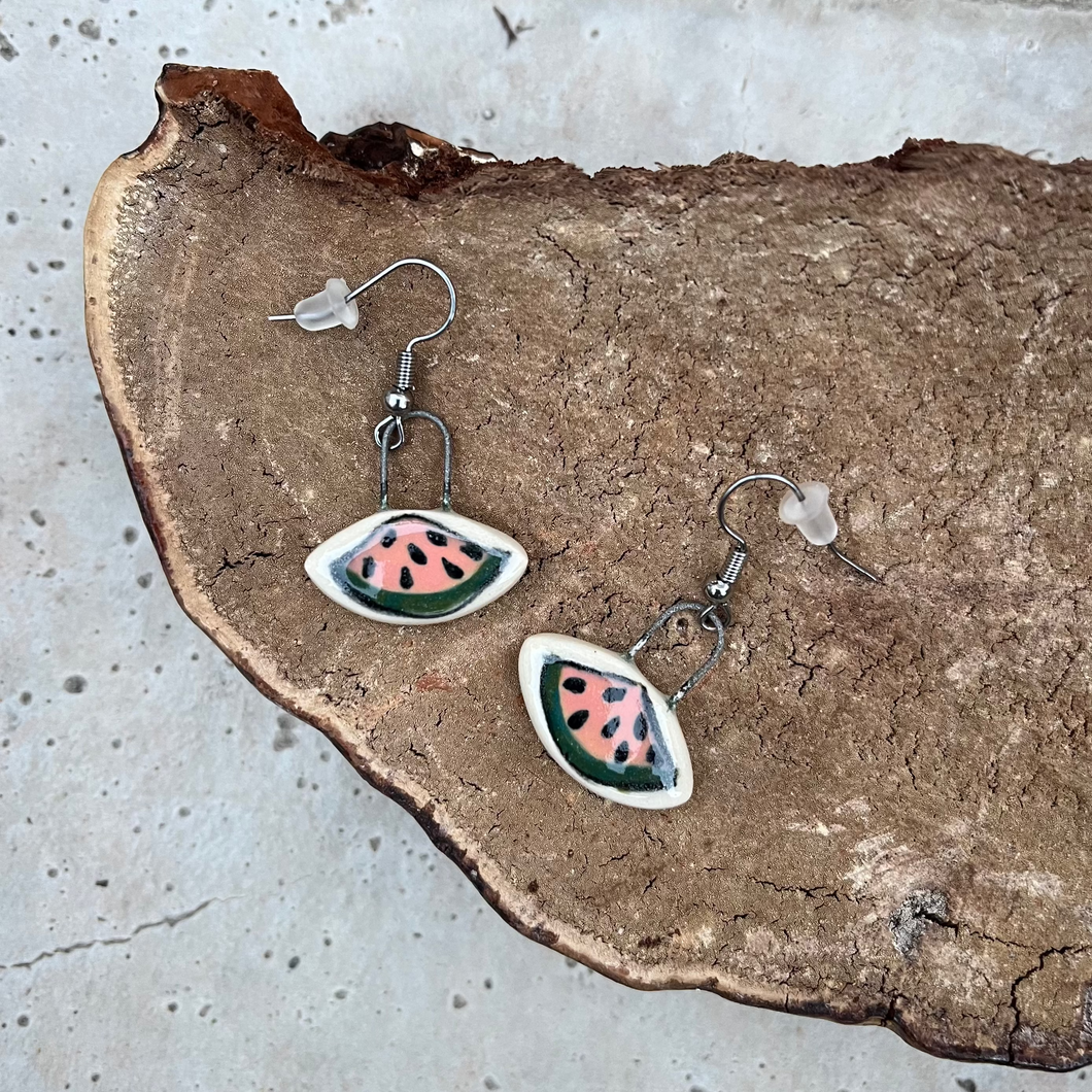 Watermelon slices hand painted on clay and made into earrings with metal ear wires.
